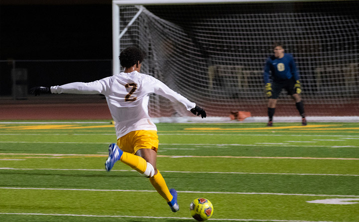 Image of Man Kicking Soccer Ball