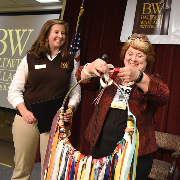 Alumni Holding Ring of Ribbons