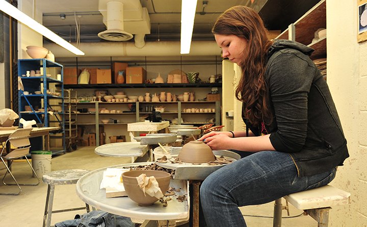 Studio art student working in ceramics studio