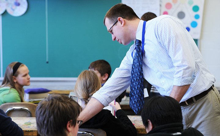 Student teacher working with middle school students