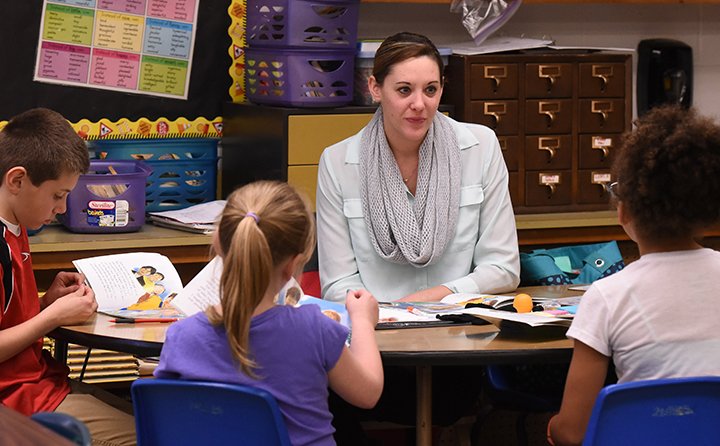 Baldwin Wallace University education major Lauryn Fougerousse works with a third-grad reading group as part of her co-student teaching program with teacher Tony Zuccaro's third grade class at Brook Pa