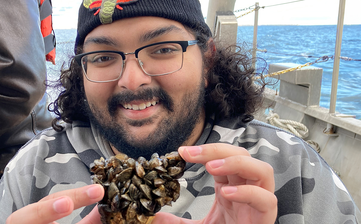 Student with mussel at field experience