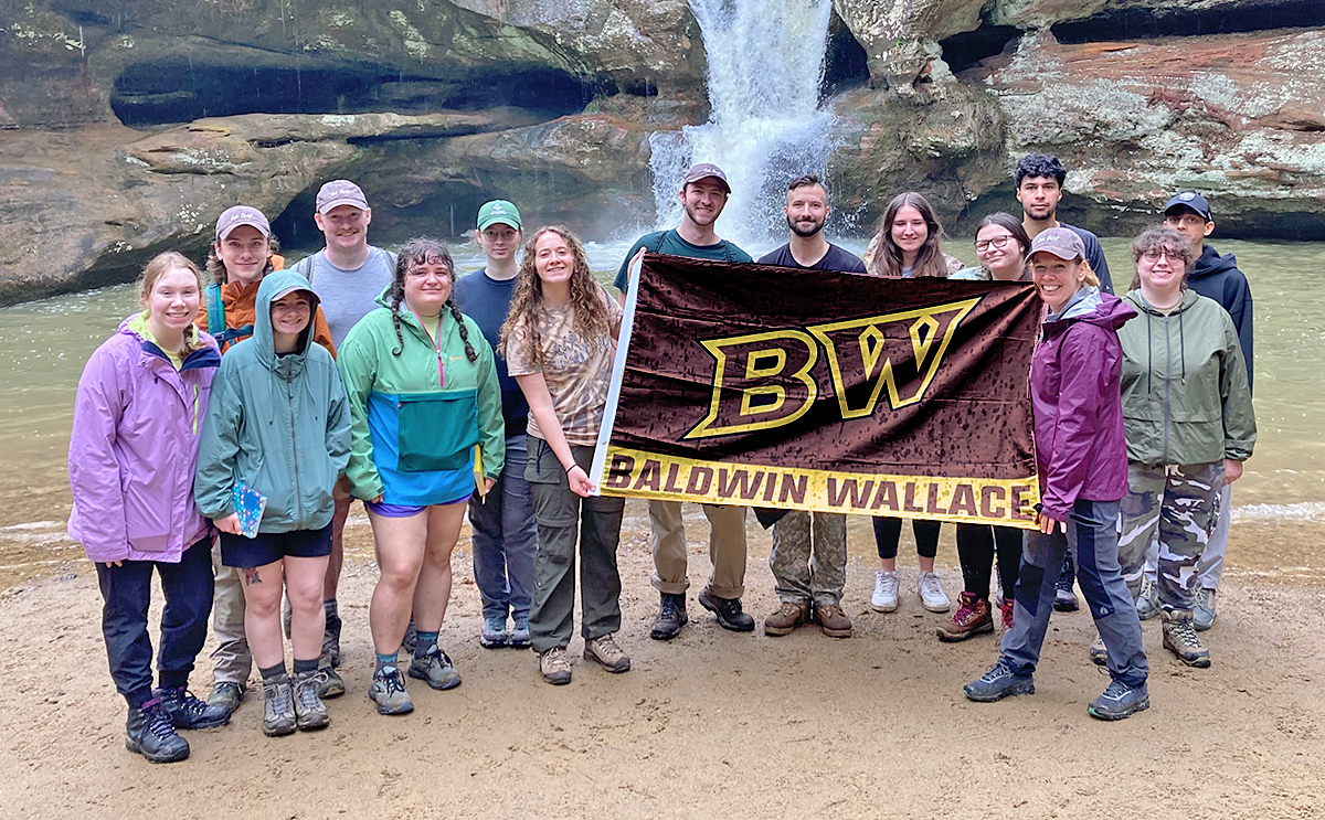 BW group with banner at field experience