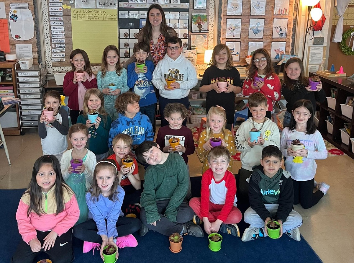 Emily Collins and her students with their plants