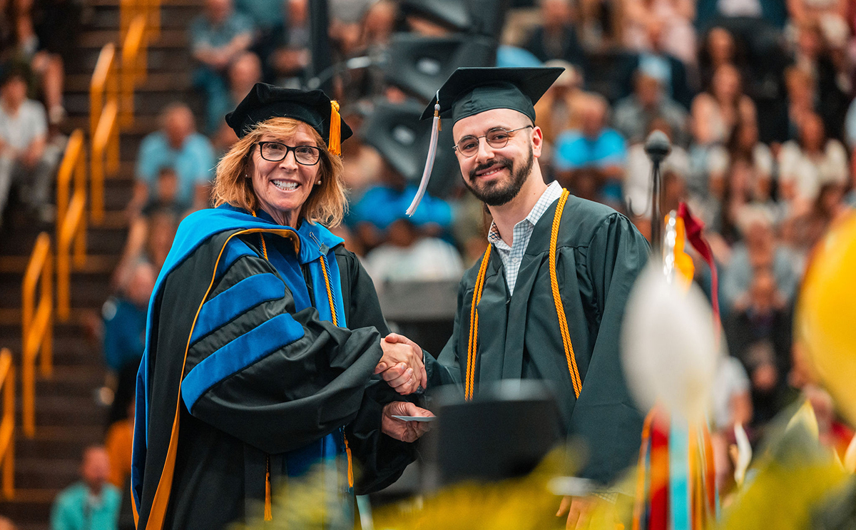 Interim Provost Linda Chase presents the Milton T. Baldwin Prize to Derek K. Schraufstetter