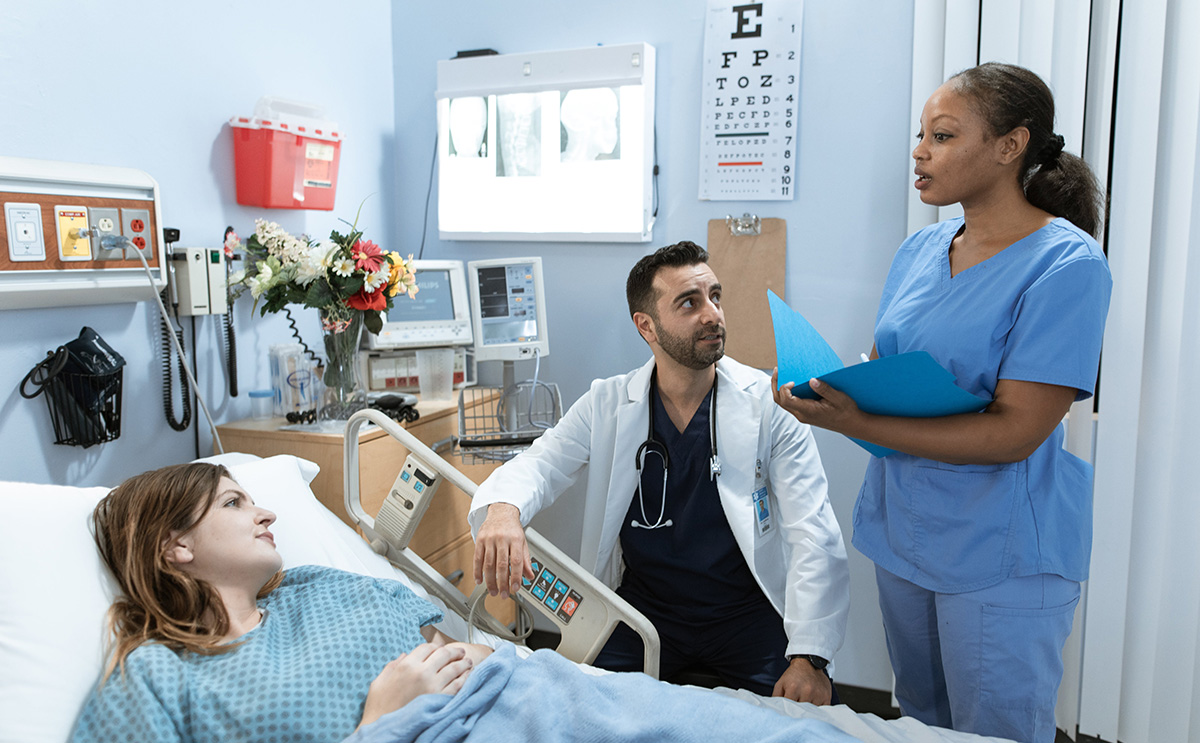 Patient and caregivers in a hospital room